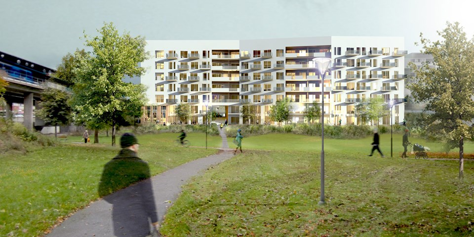 Vy över grönområde med träd och gångbana. I bakgrunden syns modernt lägenhetshus.
