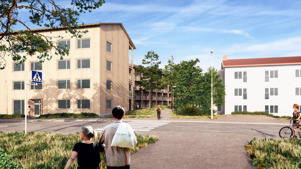 Gångväg som går mot område med flerbostadshus. Människor som promenerar