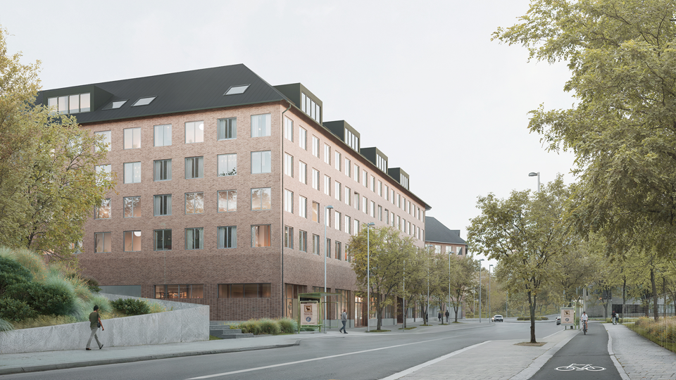 Flervåningshus i tegel längs en gata med trädplanteringar. 