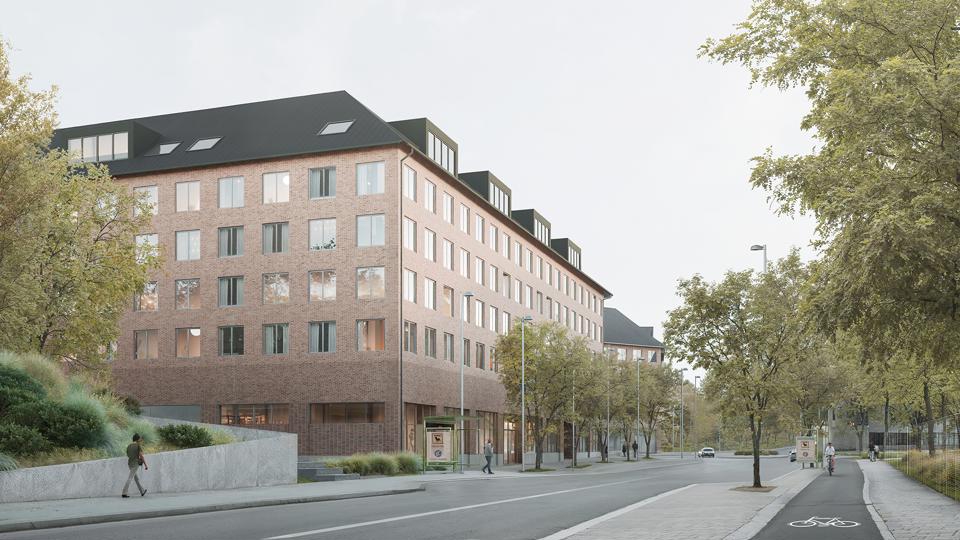 Flervåningshus i tegel längs en gata med trädplanteringar. 