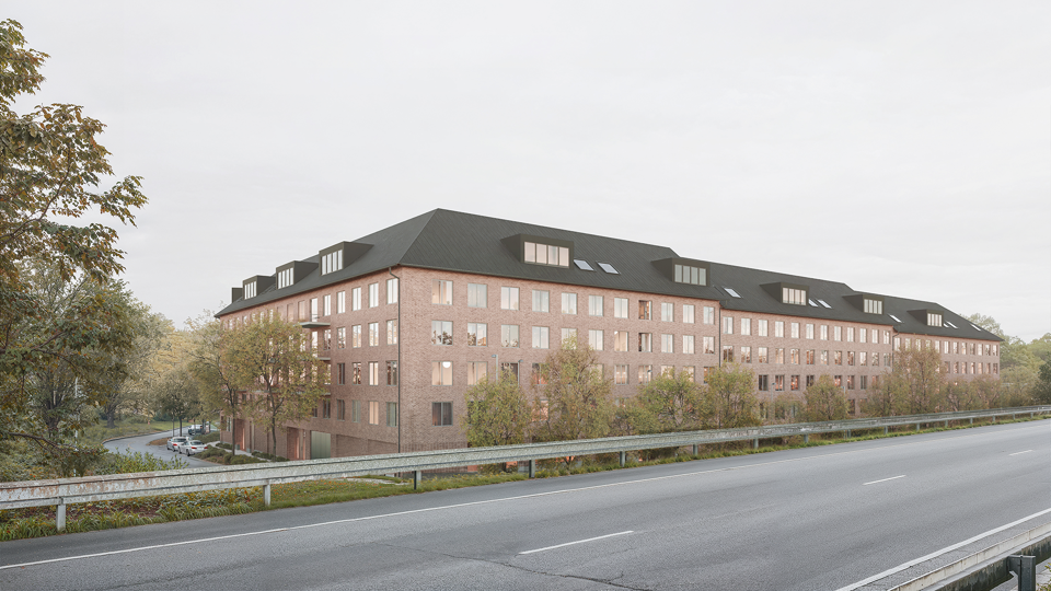 Flerbostadshus i tegel sett från motorväg