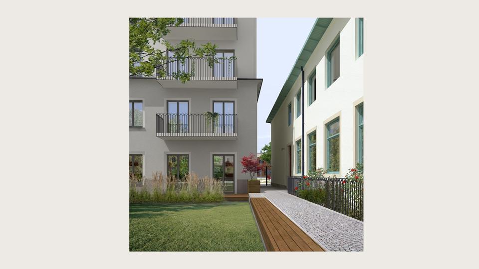 Innergård med två bostadshus som skiljs åt med en gångväg. 