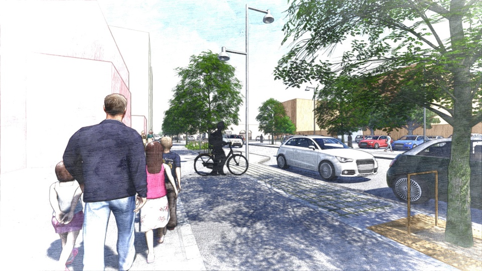 En man och tre barn går på trottoaren längs en gata.