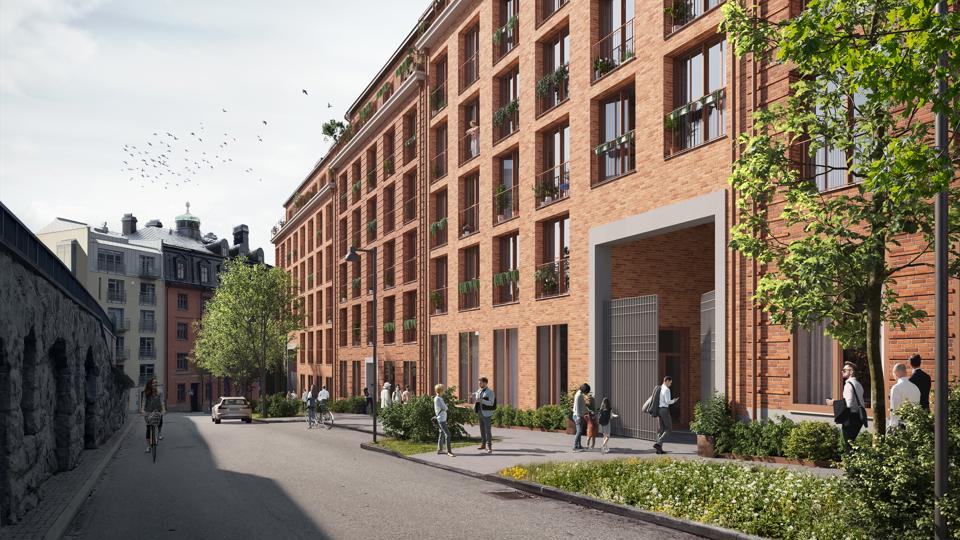Bild av en gata med flerbostadshus på var sida. Byggnaden till höger i bild är en illustration av den föreslagna bebyggelsen utfört i tegel.  