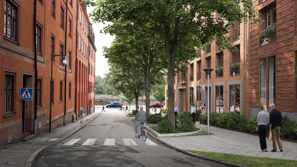 Bild av en gata med flerbostadshus på var sida. Byggnaden till höger i bild är en illustration av den föreslagna bebyggelsen utfört i tegel.  