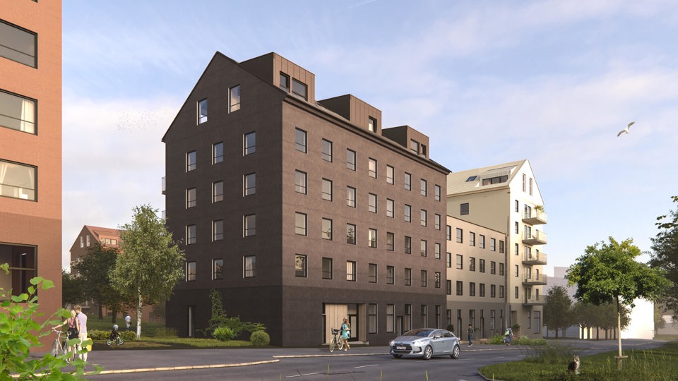 Ett sex våningar högt, brunt bostadshus om ligger i en vägkorsning. Huset sitter ihop med ett hus i ljus färg. Illustration