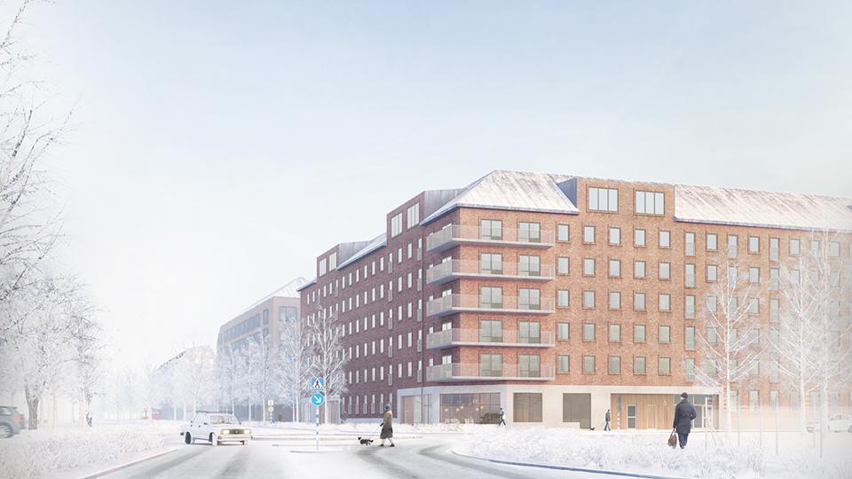 Flerbostadshus i vinkel vid en väg.