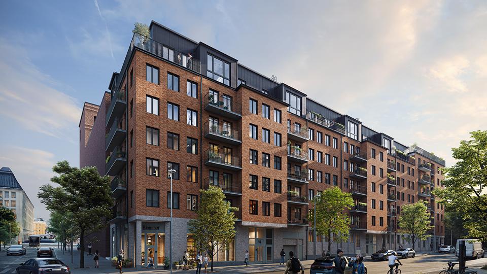 Bostadshus i tegel vid en gatukorsning. 