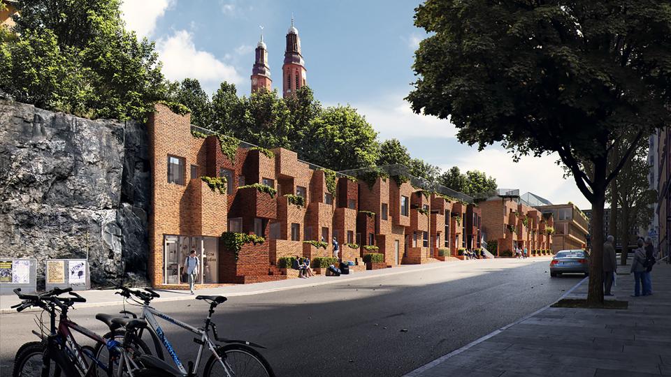 Radhus i tegel som sträcker sig längs en stadsgata. 