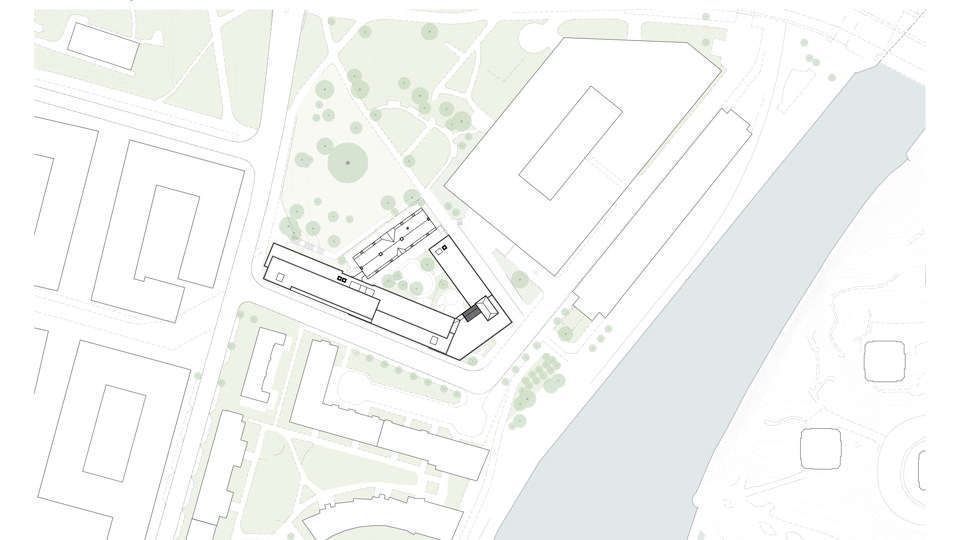 Vy ovanifrån. Byggnader skissade som vita klossar. Gröna ytor är park- eller naturmark. Träd är utmarkerade med mörkare gröna cirklar.