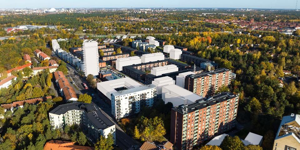 Flyg vy över planområdet med vita hus samt befintliga hus. 