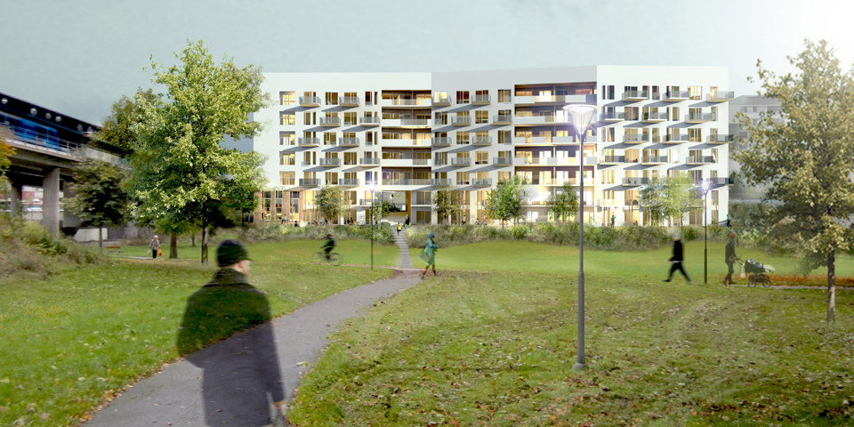 Vy över grönområde med träd och gångbana. I bakgrunden syns modernt lägenhetshus.