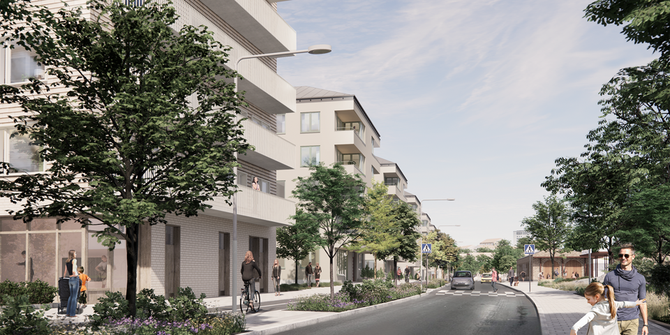 Kvarter med hus längs en gata med träd och växter. 