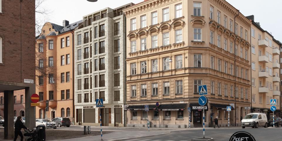 Vy mot flerbostadshus i korsning, fotografi