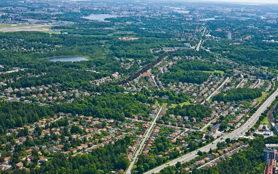 Flygvy över bostadsområden, grönområden och sjöar, foto.