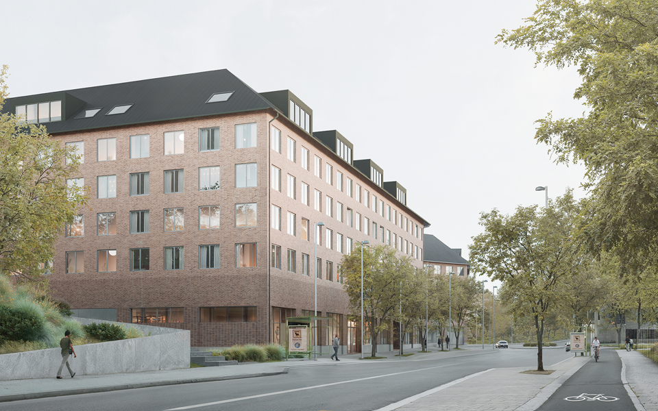 Flervåningshus i tegel längs en gata med trädplanteringar. 