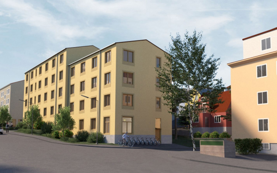 Illustration med vy från Tellusborgsvägen mot sydost. I bilden ser man det föreslagna lamellhuset i mitten. Byggnaden följer gatan nivåskillnader och är uppdelad i två volymer som båda är fyra våningar sett från kortsidan. Den volym som står lite högre upp kan därmed bli fem våningar högt i mötet med den lägre volymen. Byggnaden är indragen från gatan med grön förgårdsmark, i bilden syns buskar och buskträd mellan gatan och byggnaden. Fasaden har puts i varm, ljus kulör och sockeln är grå. Det är inga balkonger mot gatan. 