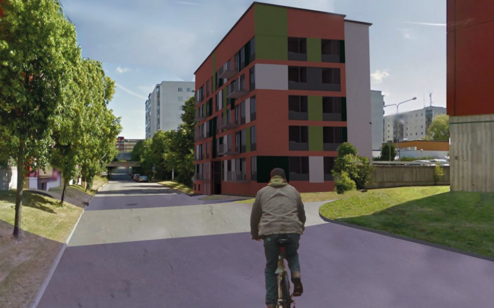 Vy längs med gata med flerbostadshus längs med, cyklist på vägen, fotomontage.