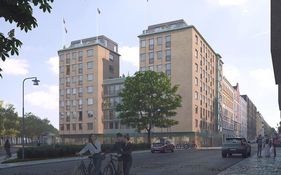 Flerbostadshus sett från marknivå med träd, gata och cyklister.