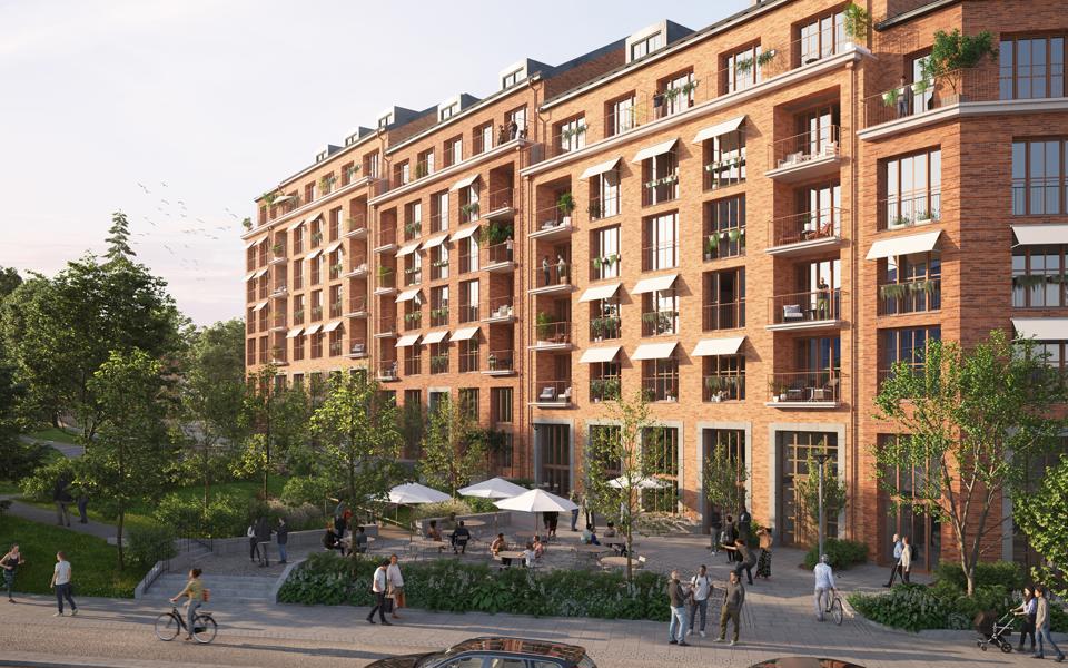 Bild av det nya bostadskvarteret med folk som använder de allmänna ytorna. 