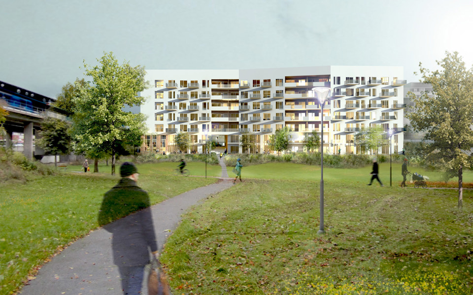 Vy över grönområde med träd och gångbana. I bakgrunden syns modernt lägenhetshus.