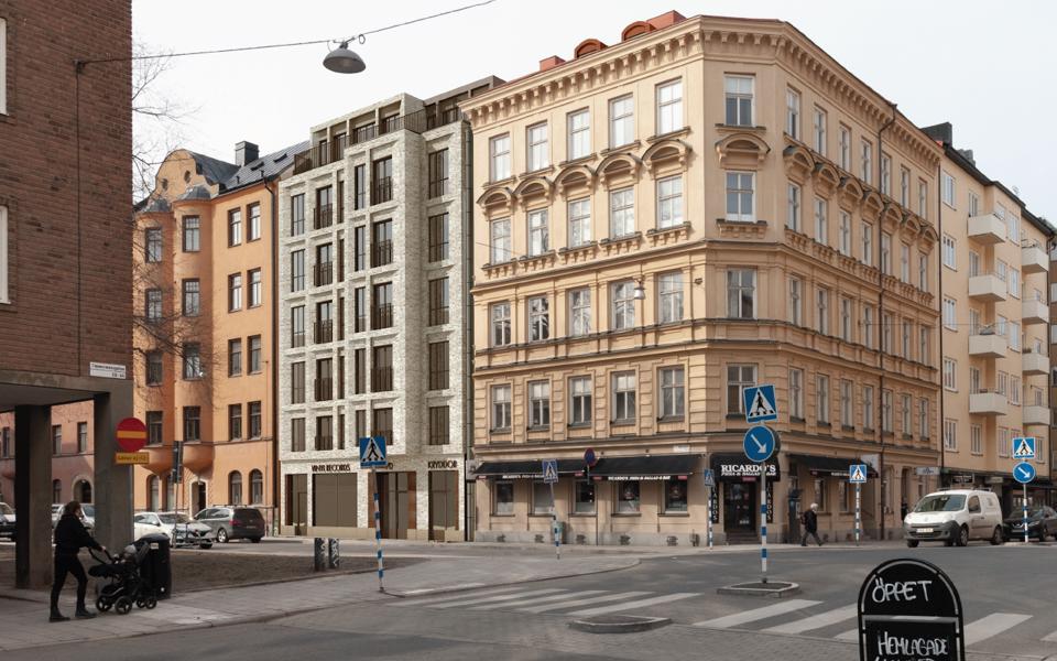 Vy mot flerbostadshus i korsning, fotografi